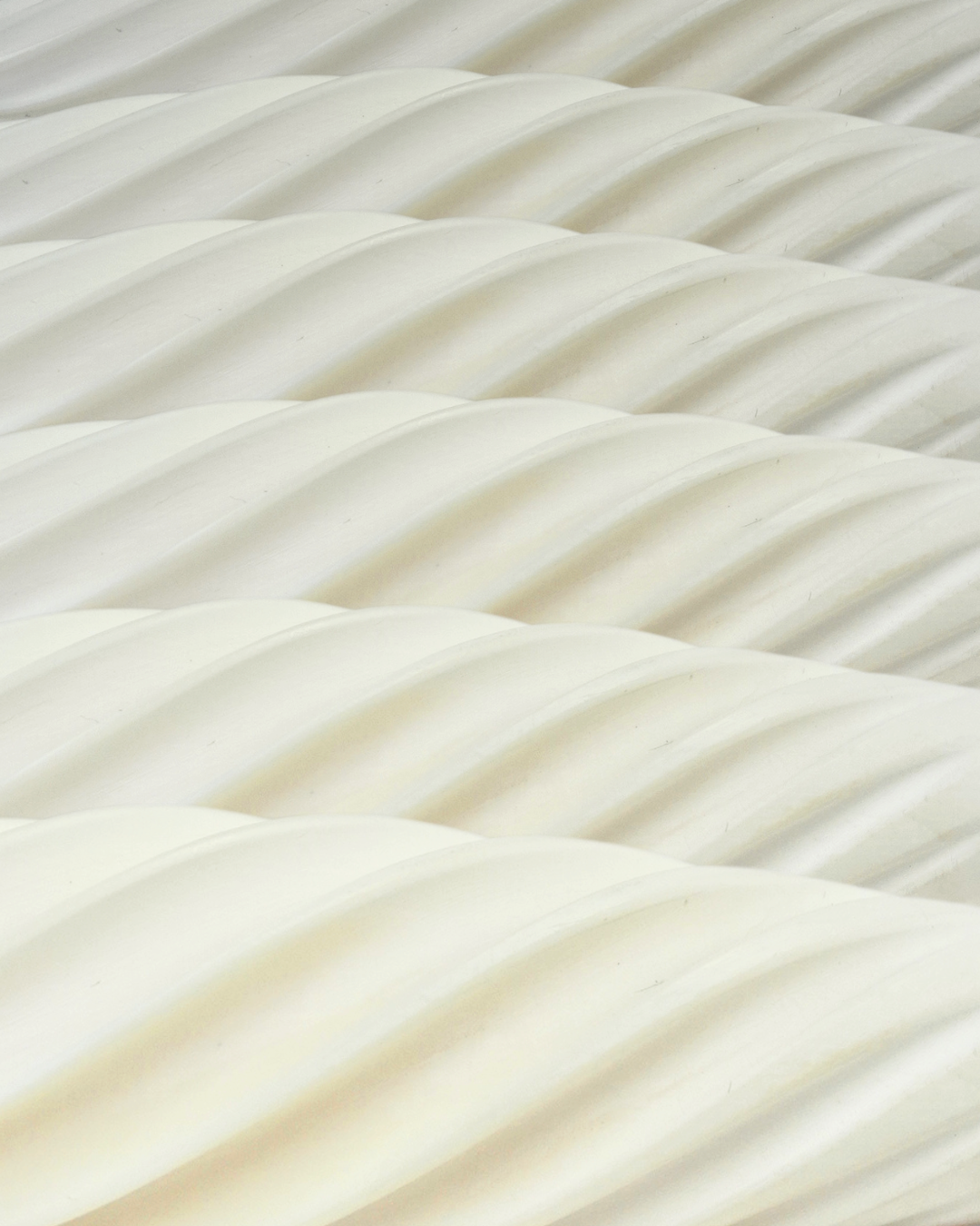 Close-up of six Fevowell Facers aligned in rows, highlighting their sculpted ceramic swirl texture and precision-crafted shape